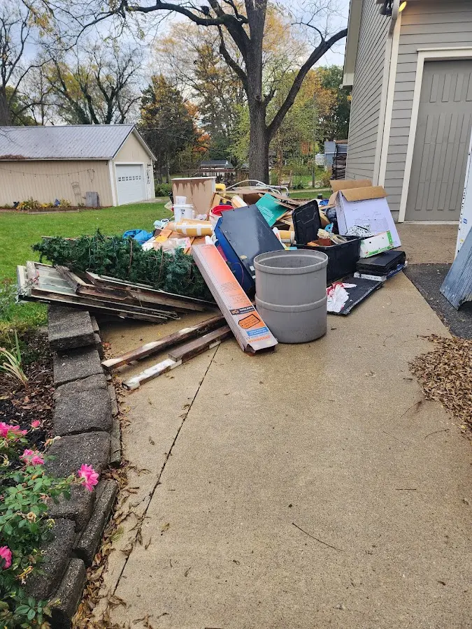 Dumpster being loaded with debris for 12 Yard Dumpster Rental in Pecan Grove